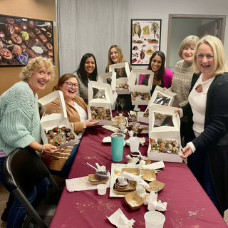 Adults enjoying a hands-on chocolate making class at Chamberlain's Chocolate Factory in Roswell, GA