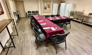 Adult Birthday Party Information ($100 deposit) setup with banquet tables and chairs in a spacious room.