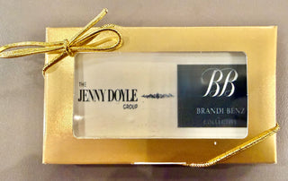 Custom Printed Business Size Chocolate Bars With Logo Ten in gold packaging with a bow, featuring brand logos.