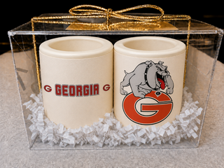 Set of 2 milk chocolate shot glasses with Georgia Bulldogs Team edible print — one with team name, one with logo — gift boxed in a clear acrylic box with silver bow, made at Chamberlain's in Roswell, GA