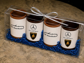 Set of 4 custom milk and dark chocolate shot glasses with edible logo prints and blue crinkle paper, clear acrylic gift box with silver ribbon bow, corporate client gift by Chamberlain's Chocolate, Atlanta GA