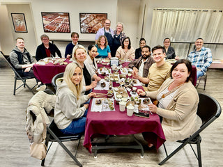 Adult Birthday Party Information ($100 deposit) group enjoying a chocolate-themed celebration at large tables with dessert.