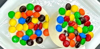 Chocolate Molded Oreos with M&M Candies topped with colorful M&M candies on a plate.