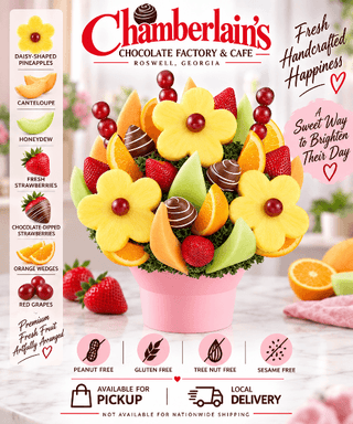 Fresh picked sweets fruit bouquet with daisy-shaped pineapple, cantaloupe, honeydew, fresh strawberries, chocolate-dipped strawberries, orange wedges, and red grapes in a pink bucket — peanut-free, gluten-free, available for local pickup and delivery from Chamberlain's in Roswell, Georgia