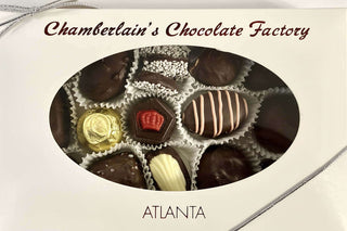 Chamberlain's Chocolate Factory one-pound dark chocolate assortment gift box with oval window display, showing an assortment of truffles, foil-wrapped chocolates, and striped ganache pieces, branded Atlanta