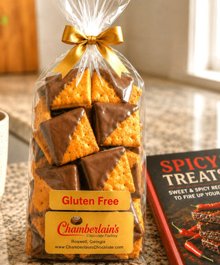 Gluten-Free Milk Chocolate Covered Cheeze-It Crackers in a clear gift bag with gold bow, labeled Chamberlain's Chocolate Factory, Roswell Georgia