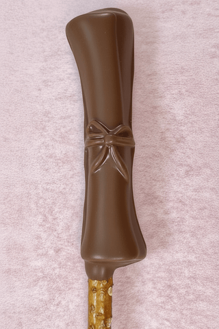 Graduation Chocolate Covered Pretzel Rods shaped like a diploma with a bow