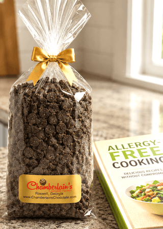 Allergen Friendly Vegan Milk Chocolate Chips packaged with yellow bow next to an allergy-free cooking book.