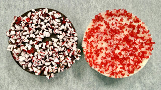 Peppermint Oreos topped with crushed candy canes and red sanding sugar, perfect holiday treat.