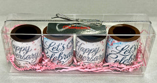 Top view of 4 anniversary chocolate shot glasses with silver edible prints in a clear gift box, Chamberlain's Chocolate Factory label, Roswell Georgia, tied with silver ribbon bow