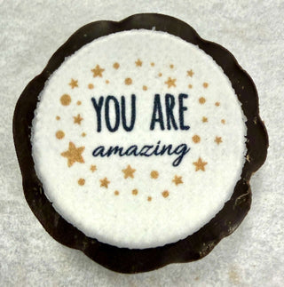 Custom Printed Small Chocolate Pieces featuring a round dark chocolate with a printed message "YOU ARE amazing".