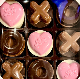 Nine Valentine Love Chocolate Oreos and Molded Chocolates featuring chocolate Xs, Os, and pink love hearts.